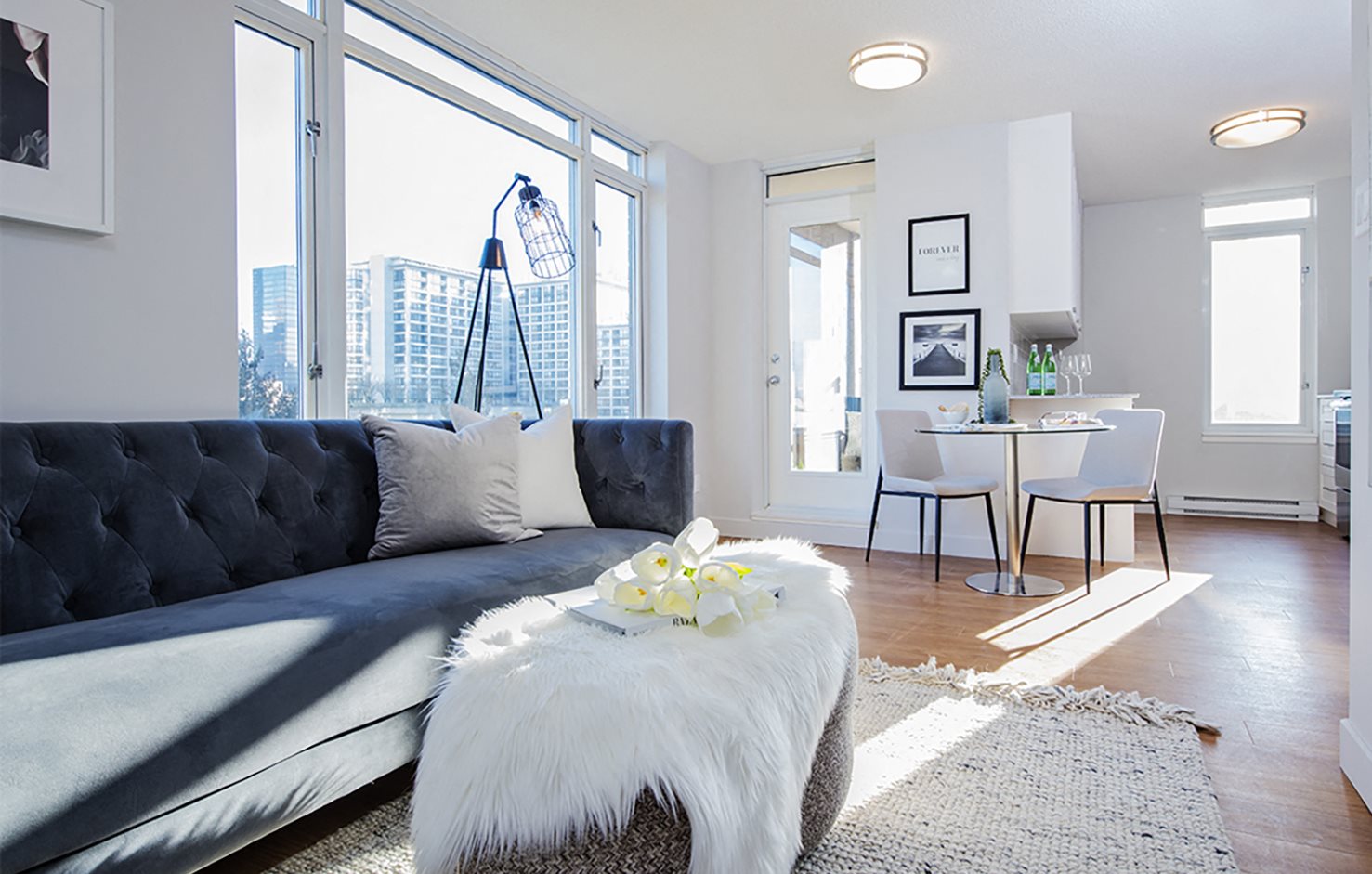 Open concept apartment with large windows at Wesley Place apartments in Vancouver, British Columbia